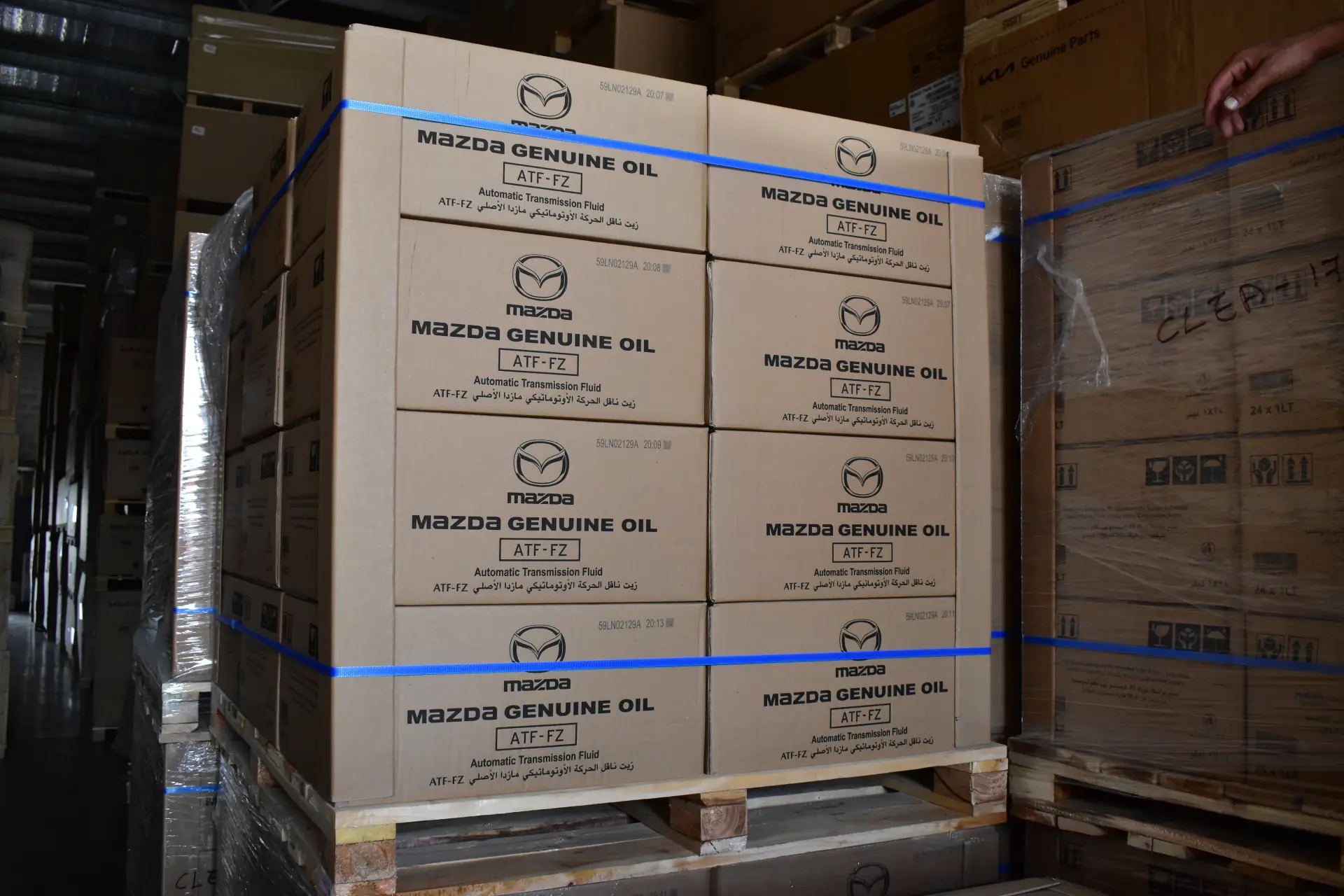Strapped pallet of Mazda genuine oil cartons being loaded for export
