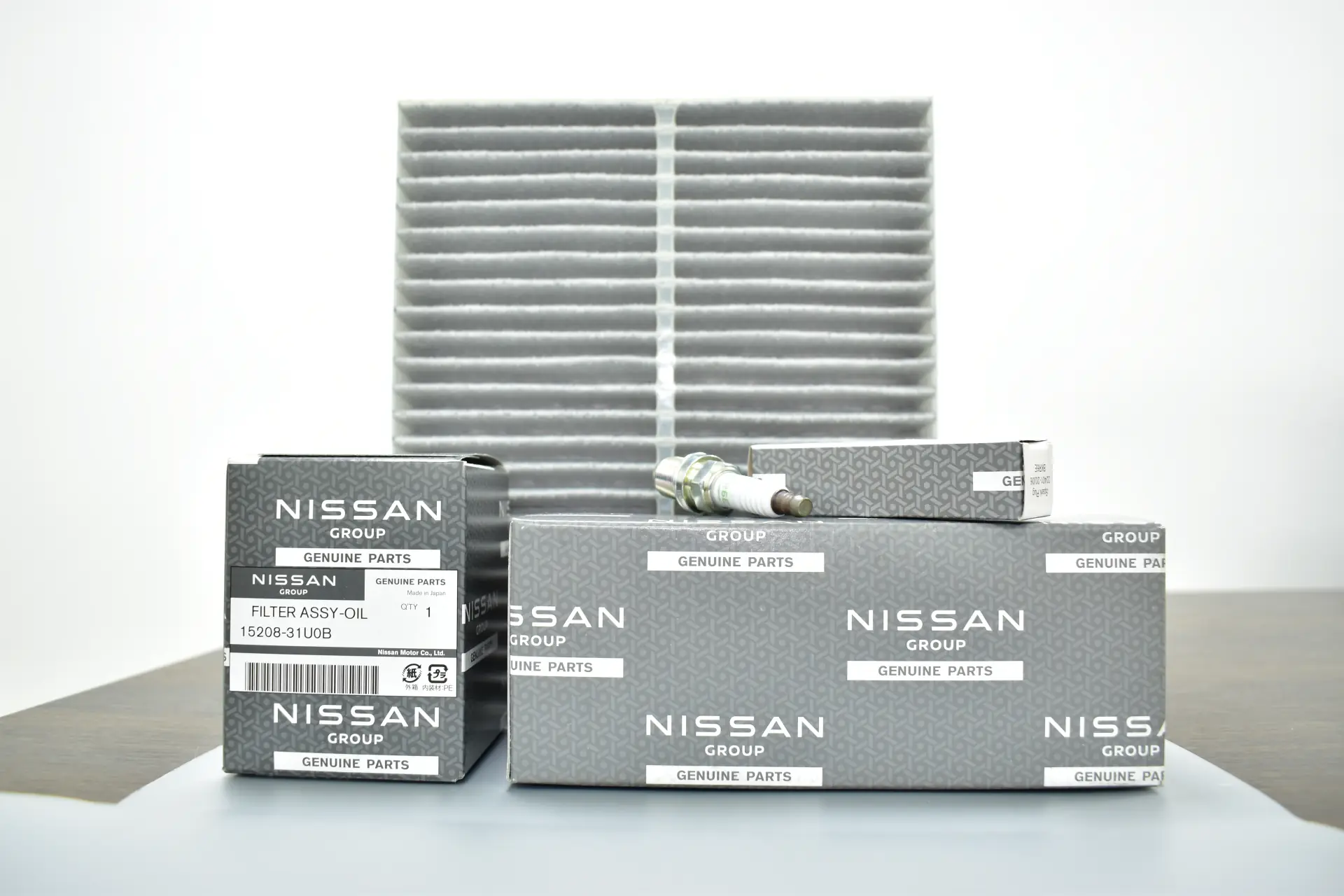 Nissan genuine oil filter, spark plug and cabin filter with their branded boxes